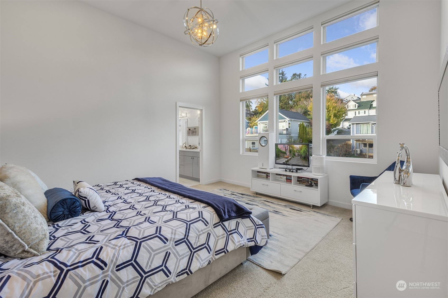 521 Southwest 3rd Place Renton, WA 98057 - Photo 23 of 32 a bedroom with a large bed and a large window with the outer view