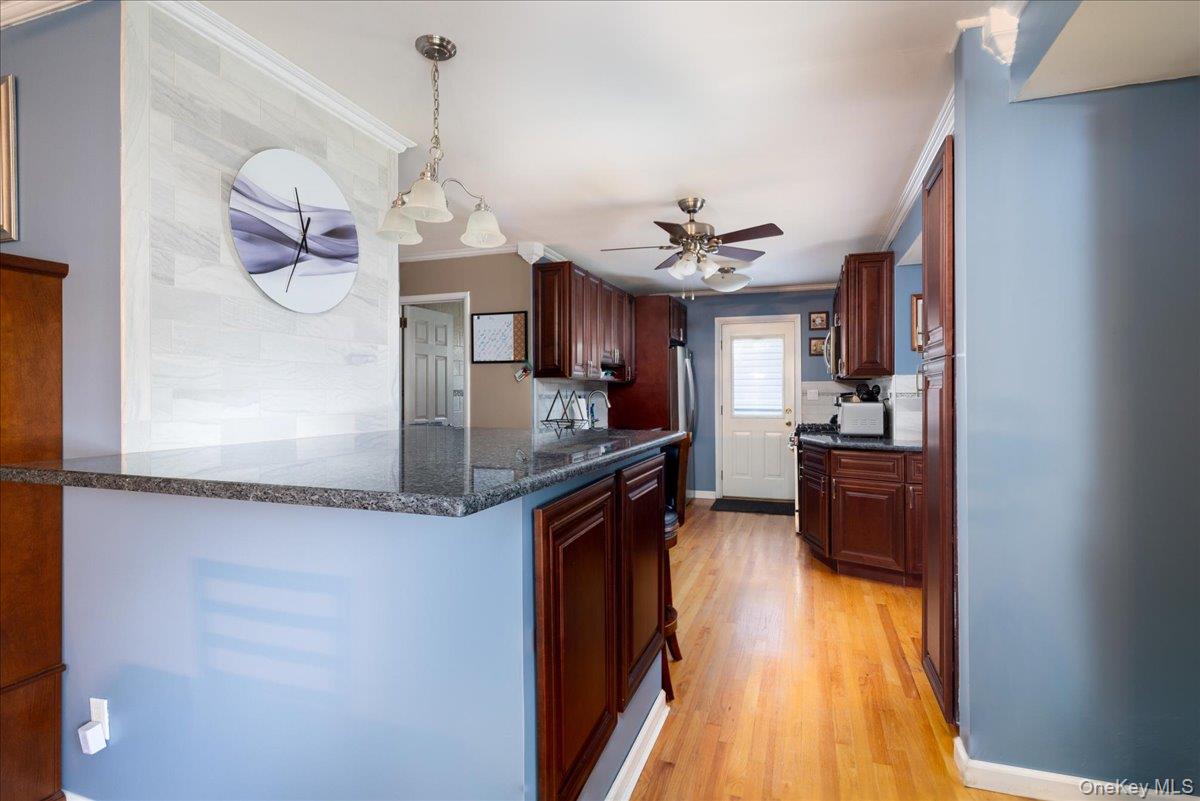 11 Adelphi Road Hicksville, NY 11801 - Photo 9 of 26 a kitchen with granite countertop a sink cabinets and stainless steel appliances