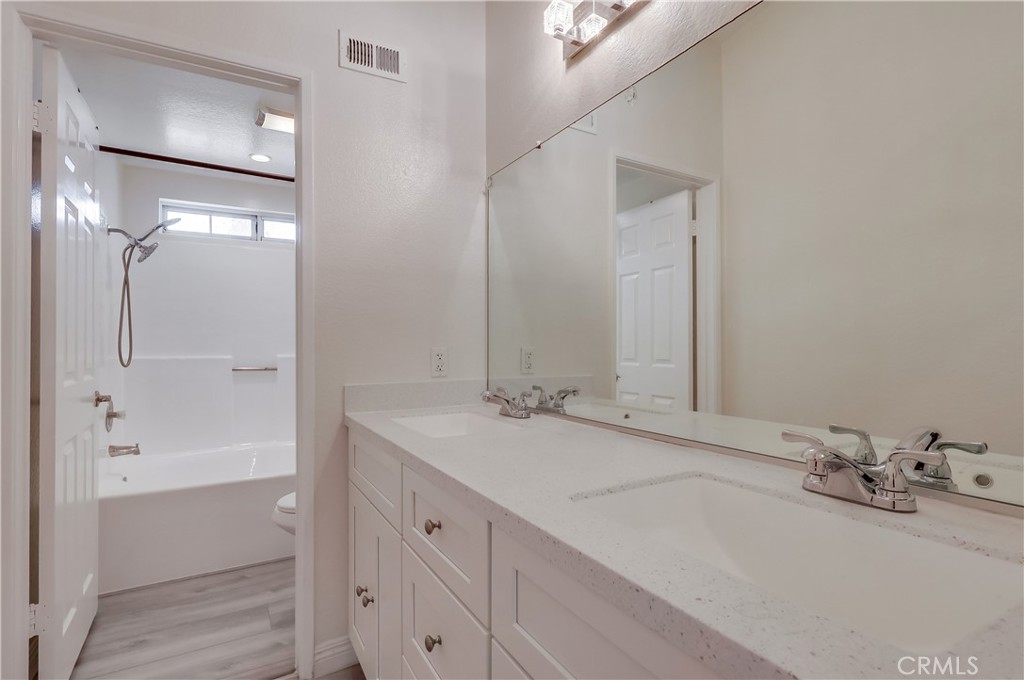 1876 Forest Drive Azusa, CA 91702 - Photo 13 of 24 a bathroom with a tub sink and mirror