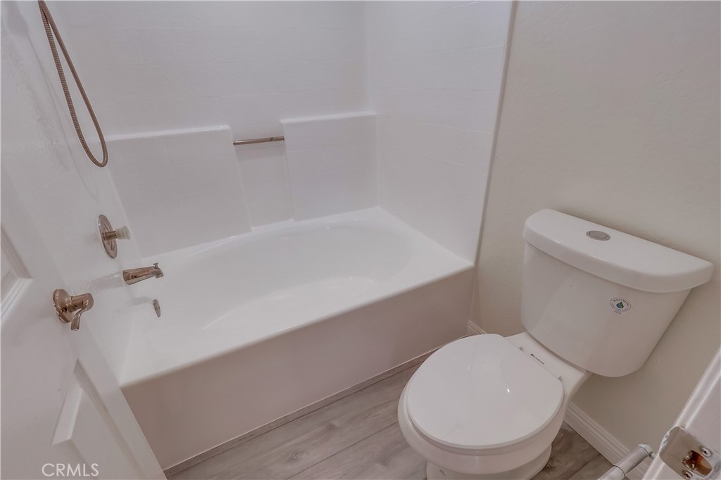 1876 Forest Drive Azusa, CA 91702 - Photo 14 of 24 a white toilet sitting next to a bath tub