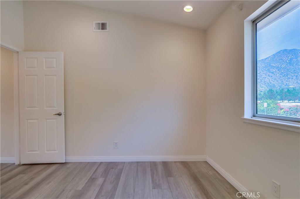 1876 Forest Drive Azusa, CA 91702 - Photo 16 of 24 a view of an empty room with wooden floor and a window