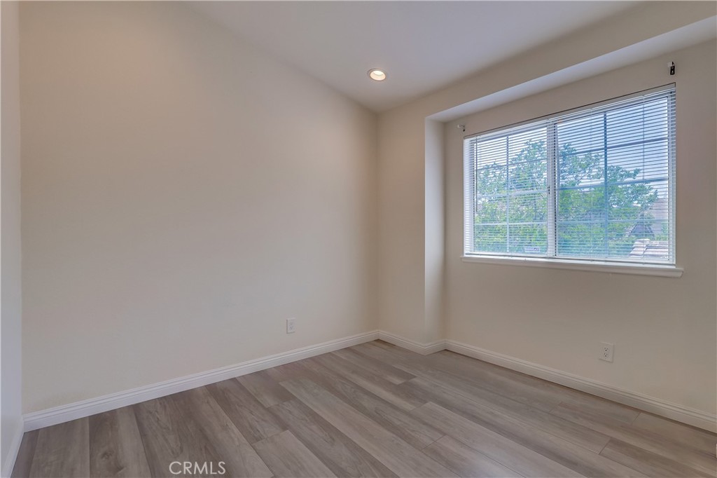 1876 Forest Drive Azusa, CA 91702 - Photo 19 of 24 an empty room with wooden floor and windows