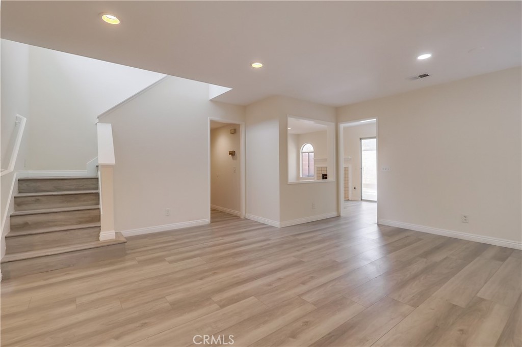 1876 Forest Drive Azusa, CA 91702 - Photo 4 of 24 a view of an empty room with wooden floor and windows