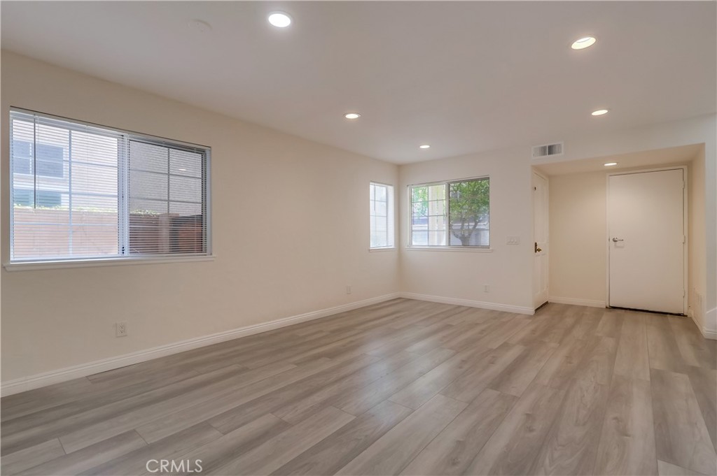 1876 Forest Drive Azusa, CA 91702 - Photo 5 of 24 an empty room with wooden floor and windows