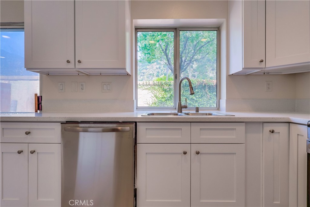 1876 Forest Drive Azusa, CA 91702 - Photo 8 of 24 a kitchen with stainless steel appliances white cabinets and a window