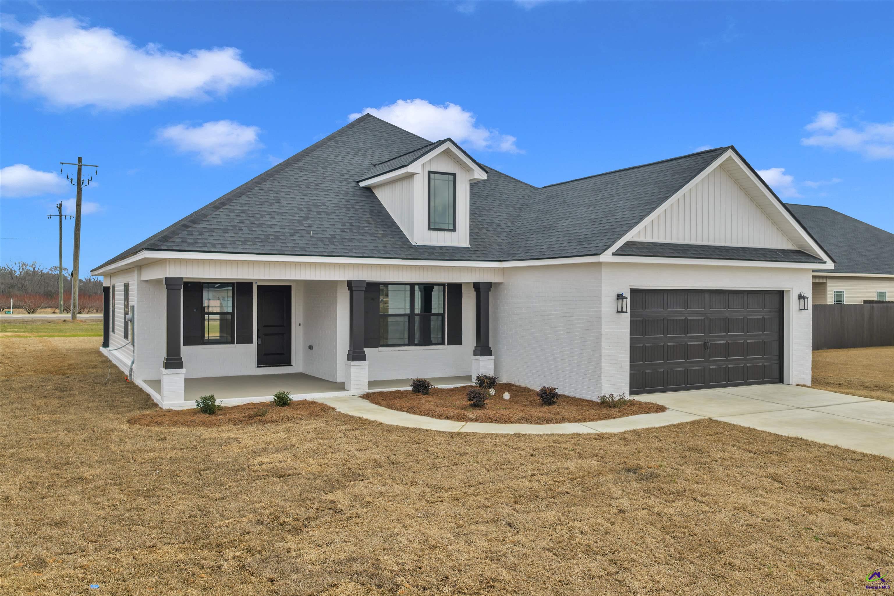 103 Early Drive Byron, GA 31008 - Photo 4 of 56 a front view of a house with a yard