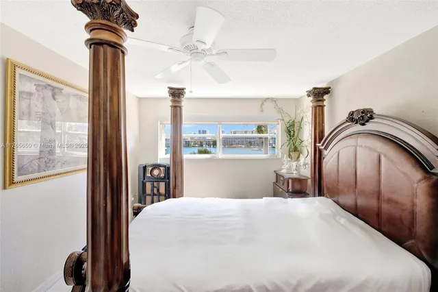 a bedroom with a bed and a painting on the wall