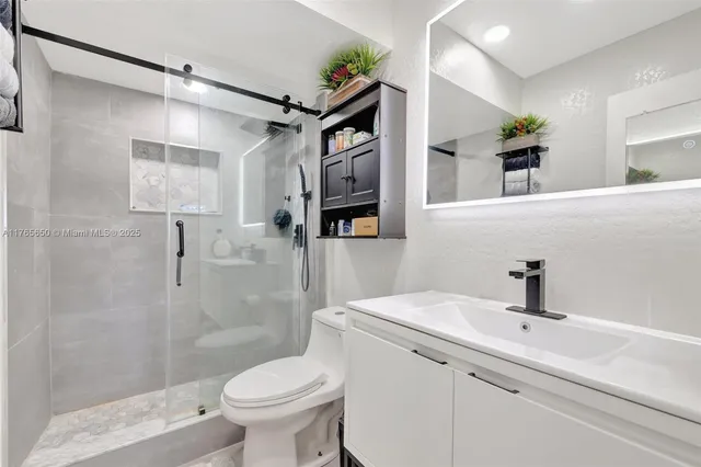 a bathroom with a sink a toilet and mirror