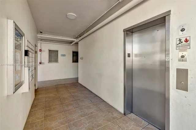 a front view of a house with a yard and potted plants