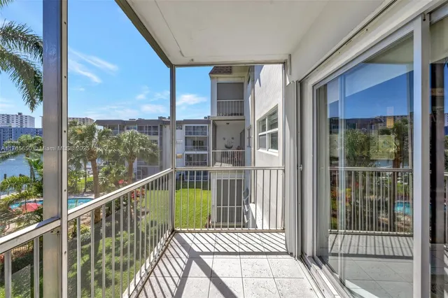 a view of a balcony with a floor to ceiling window and wooden floor
