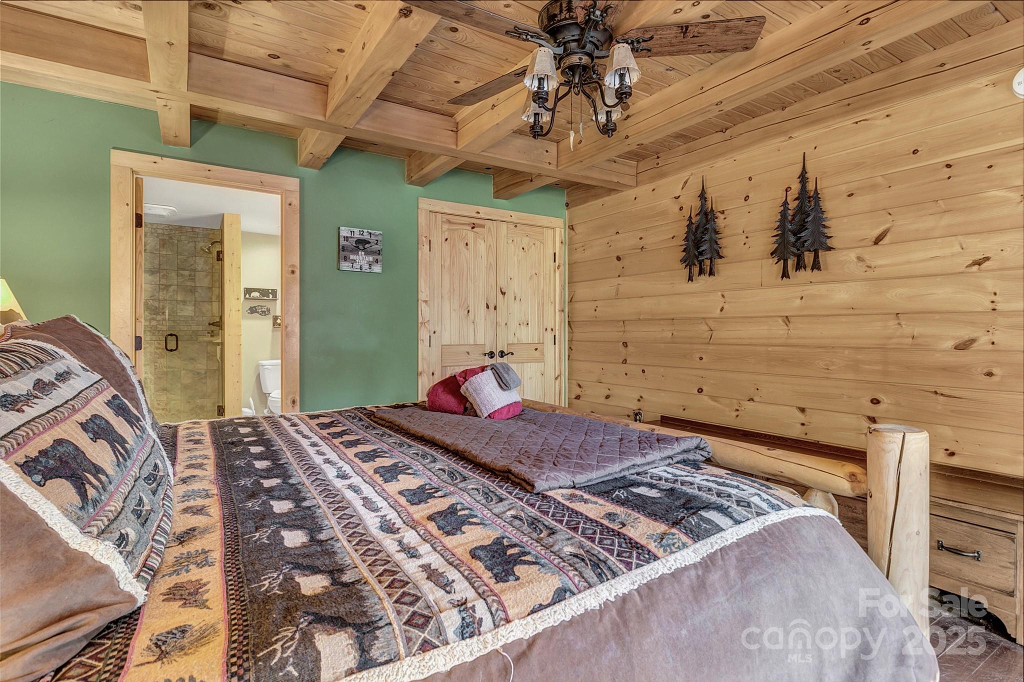 120 Sweetbriar Road North Lake Lure, NC 28746 - Photo 13 of 45 a bedroom with a bed and a chandelier