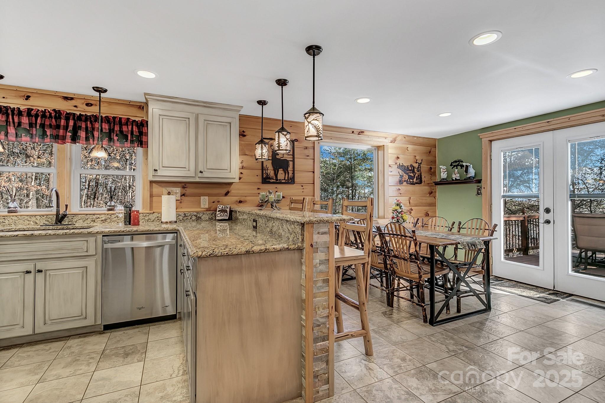 120 Sweetbriar Road North Lake Lure, NC 28746 - Photo 16 of 45 a kitchen with stainless steel appliances granite countertop a table and chairs in it