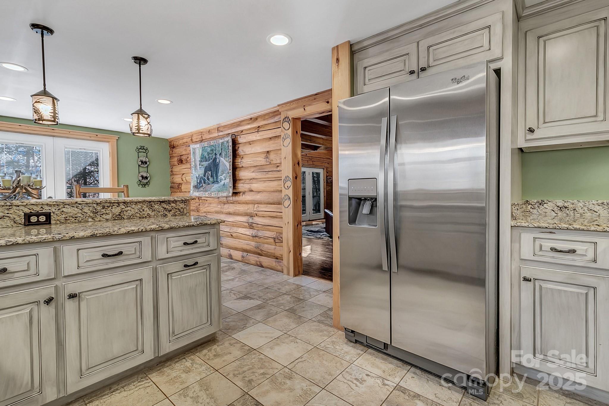 120 Sweetbriar Road North Lake Lure, NC 28746 - Photo 17 of 45 a kitchen with granite countertop a refrigerator and cabinets