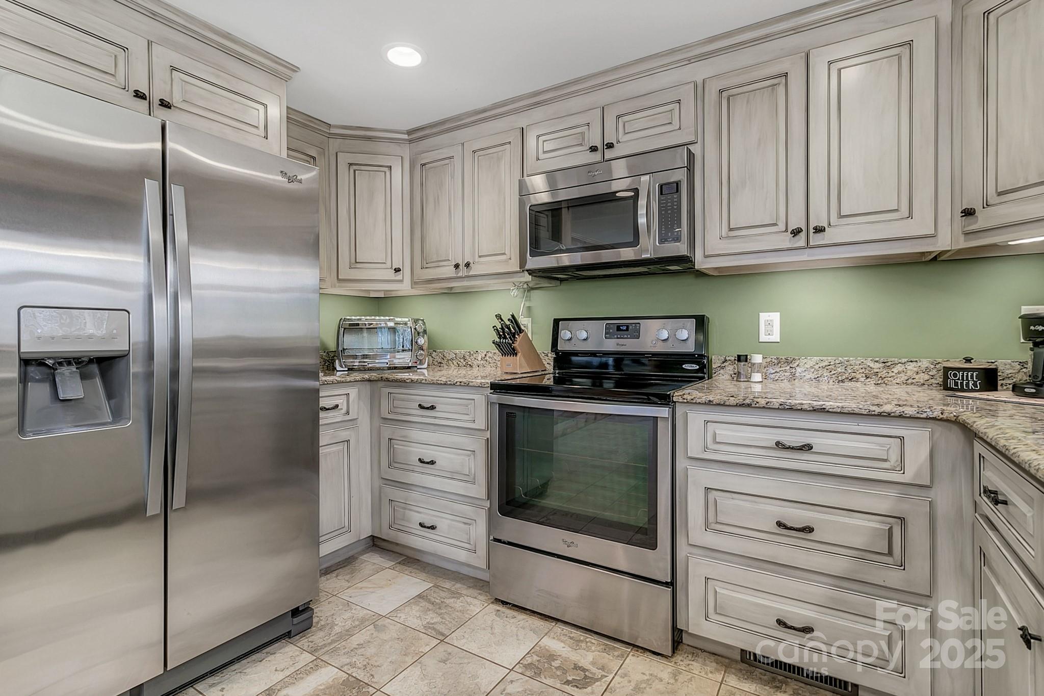 120 Sweetbriar Road North Lake Lure, NC 28746 - Photo 18 of 45 a kitchen with white cabinets stainless steel appliances and a sink