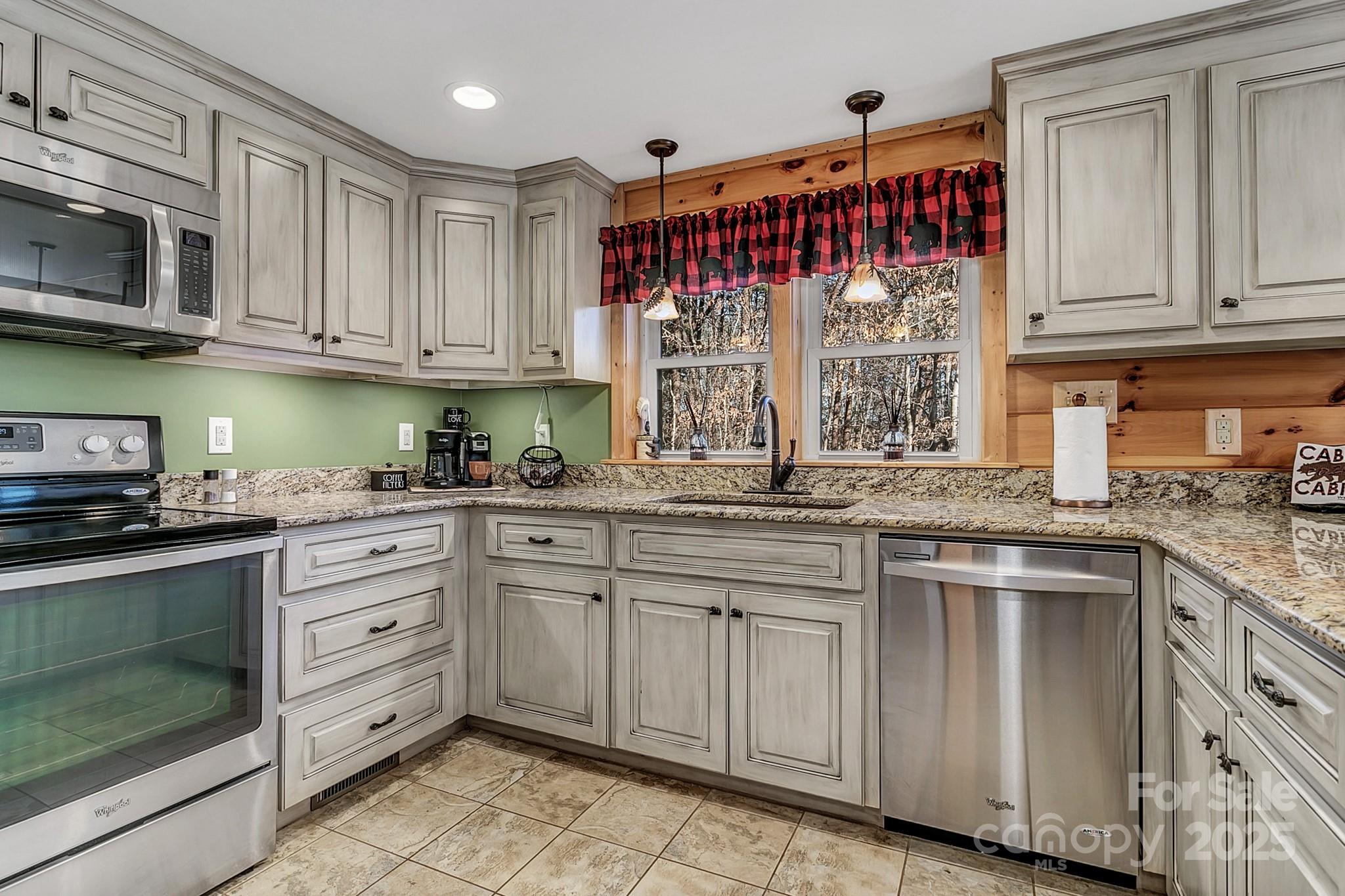 120 Sweetbriar Road North Lake Lure, NC 28746 - Photo 19 of 45 a kitchen with stainless steel appliances granite countertop a sink and cabinets