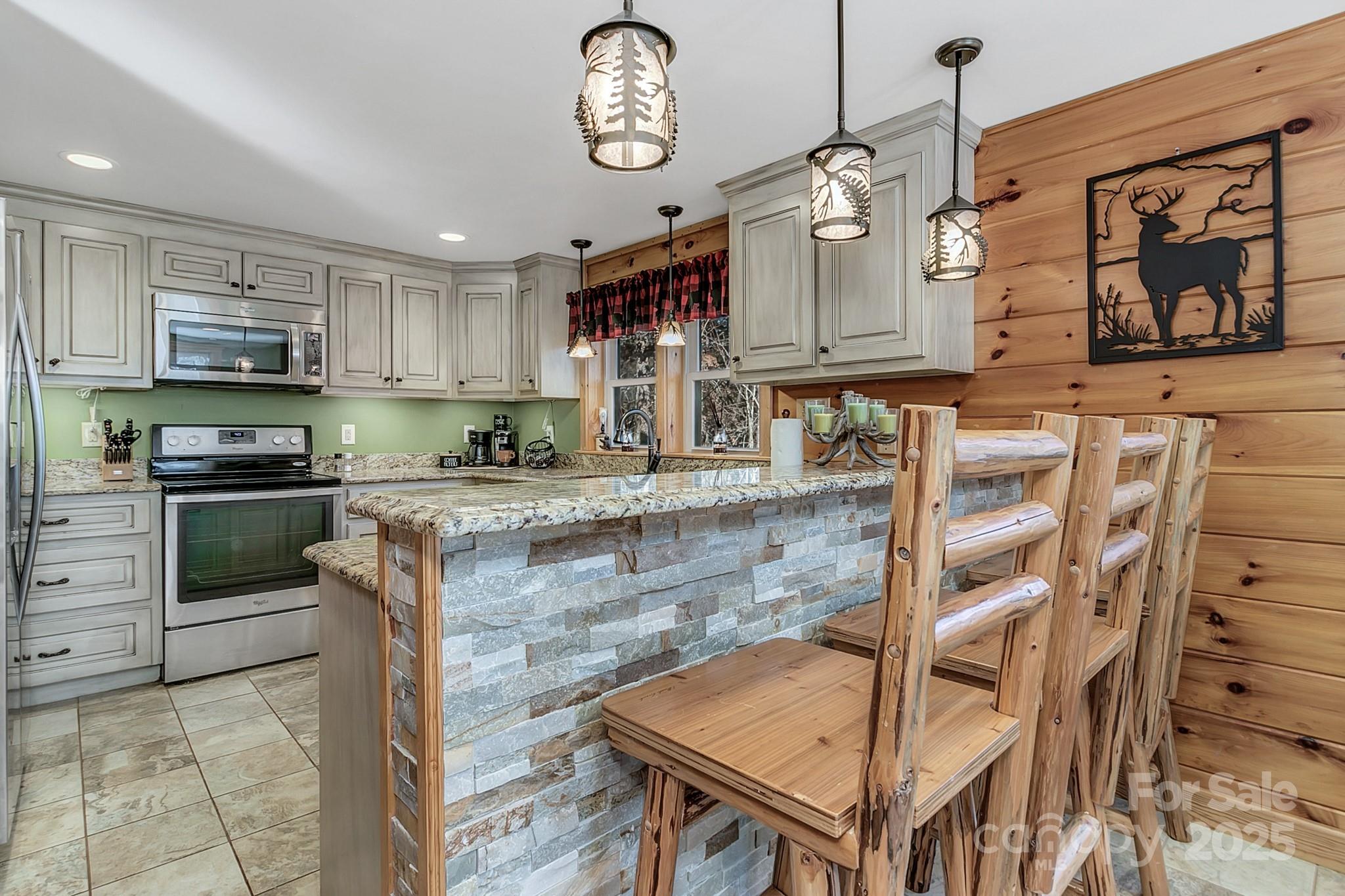 120 Sweetbriar Road North Lake Lure, NC 28746 - Photo 20 of 45 a kitchen with stainless steel appliances granite countertop a stove a sink and a microwave