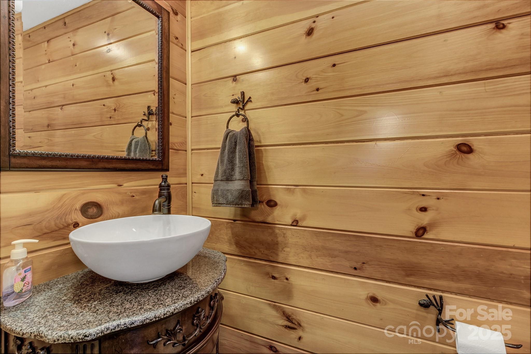 120 Sweetbriar Road North Lake Lure, NC 28746 - Photo 24 of 45 a bathroom with a granite countertop sink and mirror