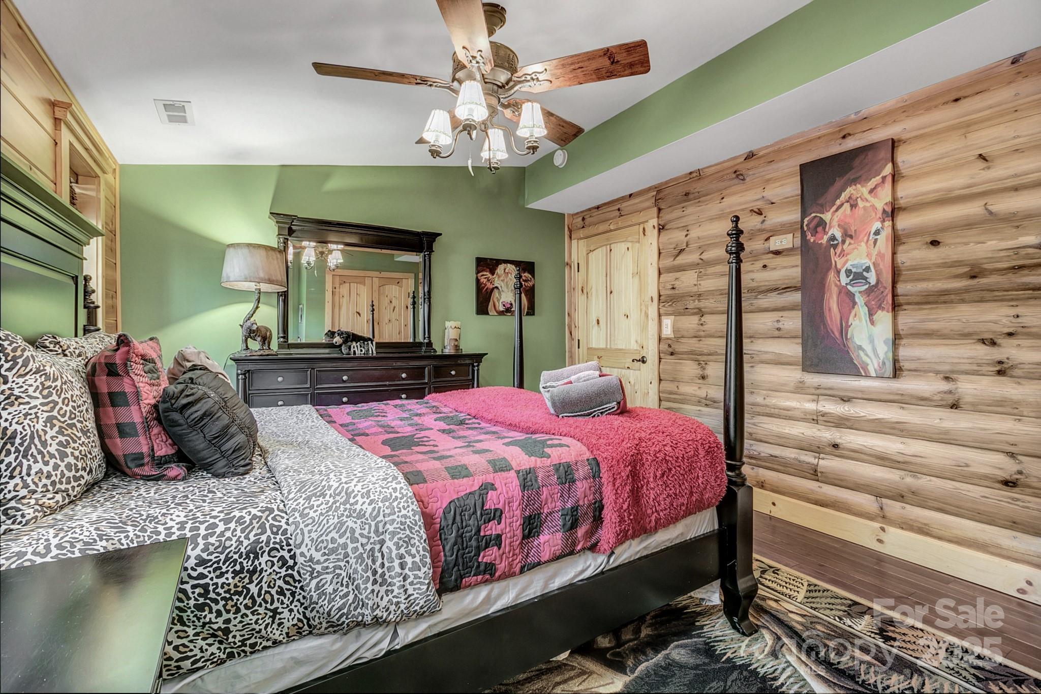 120 Sweetbriar Road North Lake Lure, NC 28746 - Photo 33 of 45 a bedroom with a large bed and a chandelier