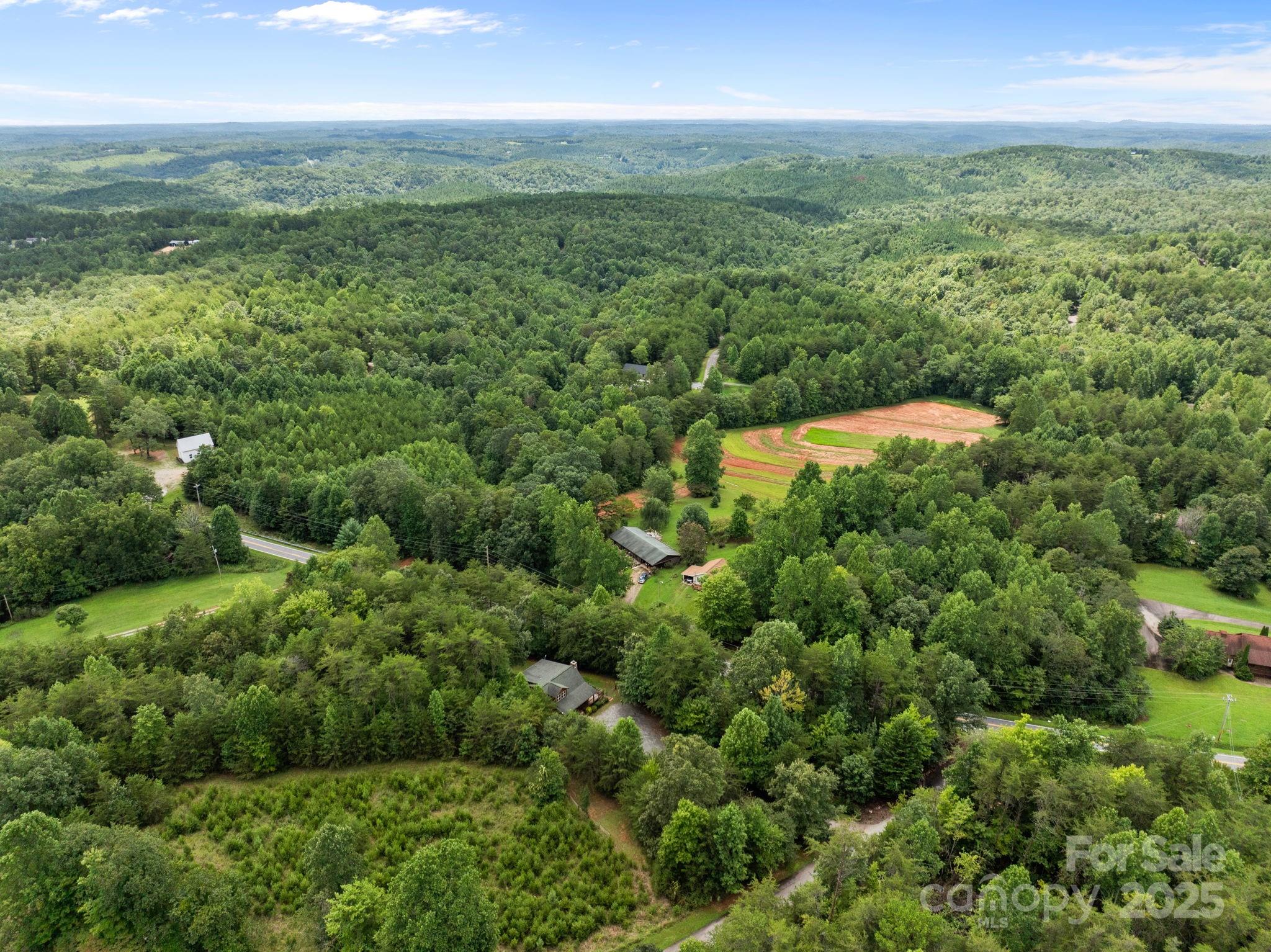 120 Sweetbriar Road North Lake Lure, NC 28746 - Photo 39 of 45 a view of a green field with lots of bushes