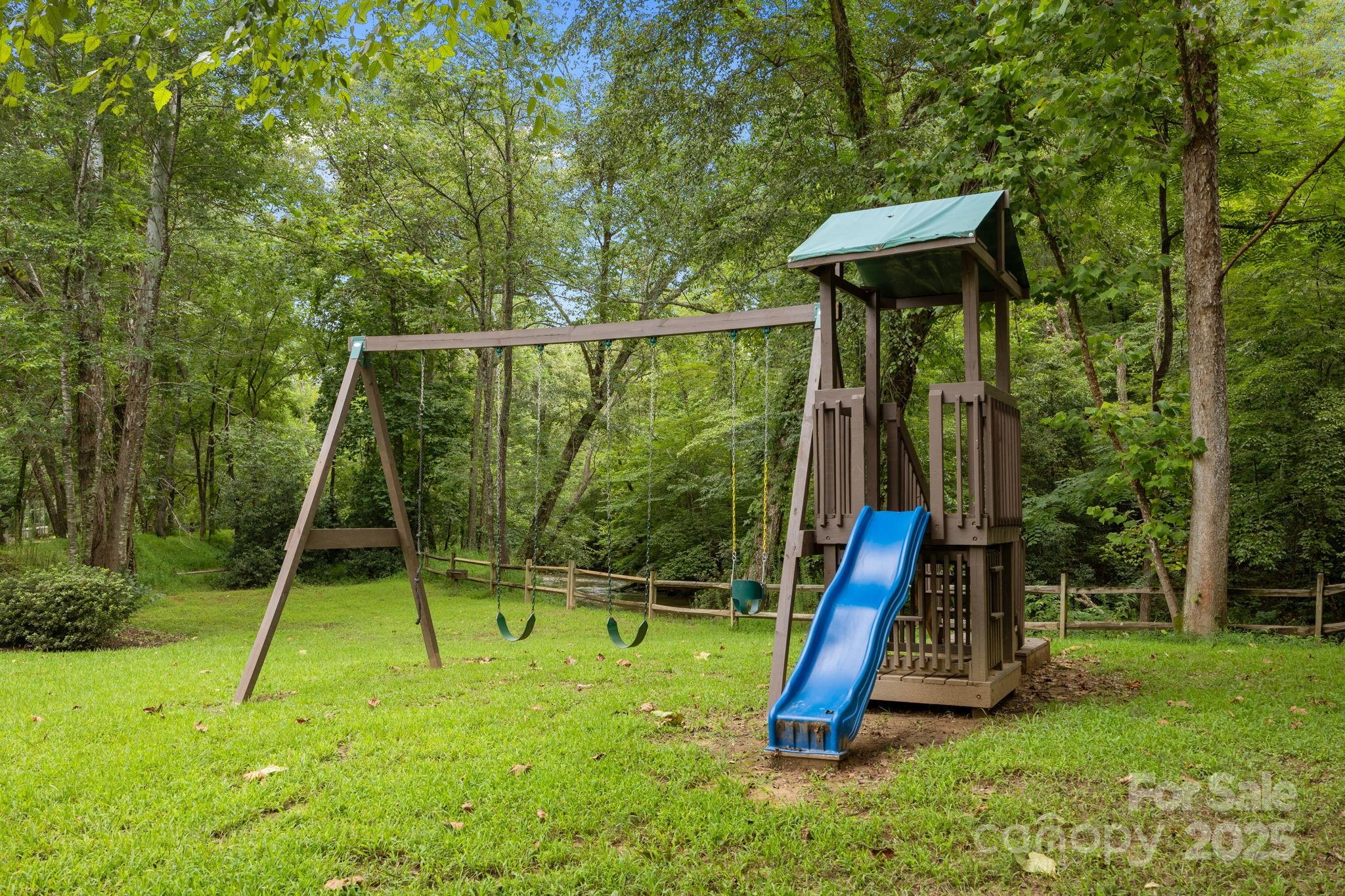 120 Sweetbriar Road North Lake Lure, NC 28746 - Photo 44 of 45 a view of a backyard with a slide and a child swing