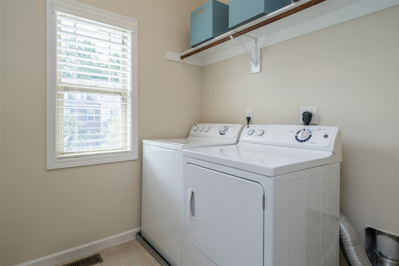 5630 Wade Park Boulevard Raleigh, NC 27607 - Photo 24 of 30 Washer and dryer included! Ceramic tile on the floors and wooden shelving above! Beautiful window with street view! Laundry Room