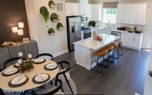 a kitchen with a table chairs stove and kitchen island