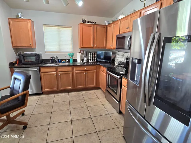 a kitchen with stainless steel appliances granite countertop a refrigerator stove and sink