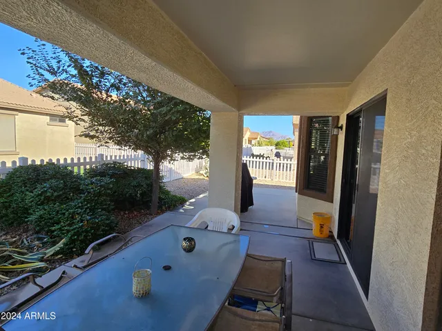 a view of a porch with wooden floor and fence