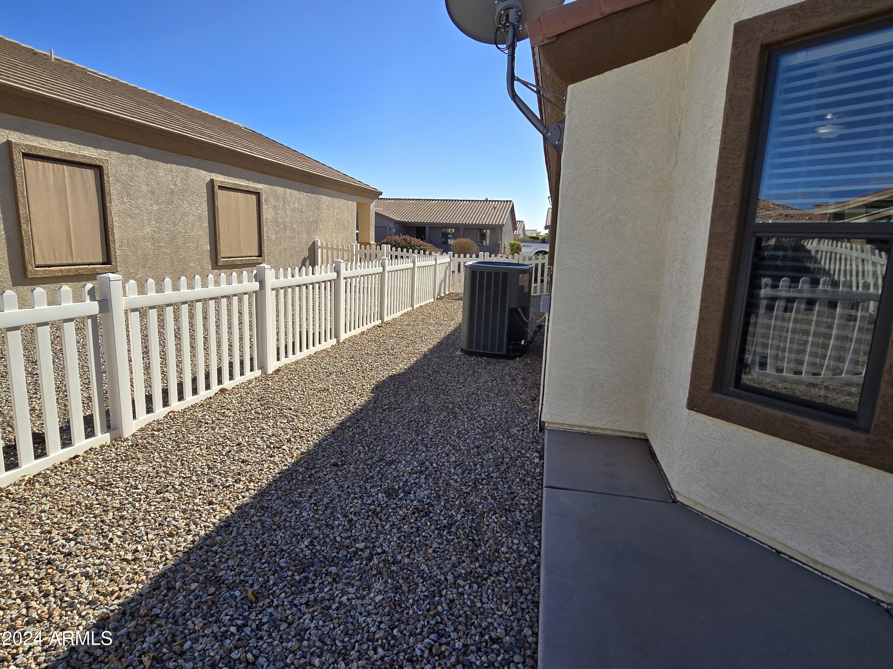 2101 South Meridian Road, Unit 274 Apache Junction, AZ 85120 - Photo 27 of 58 a view of a porch with wooden floor and fence