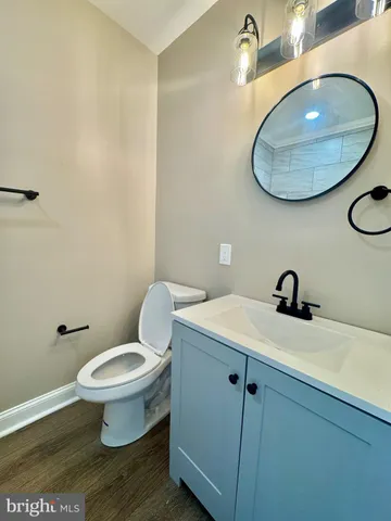 a bathroom with a toilet a sink and mirror