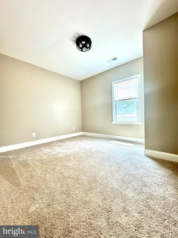 an empty room with a empty space and a window