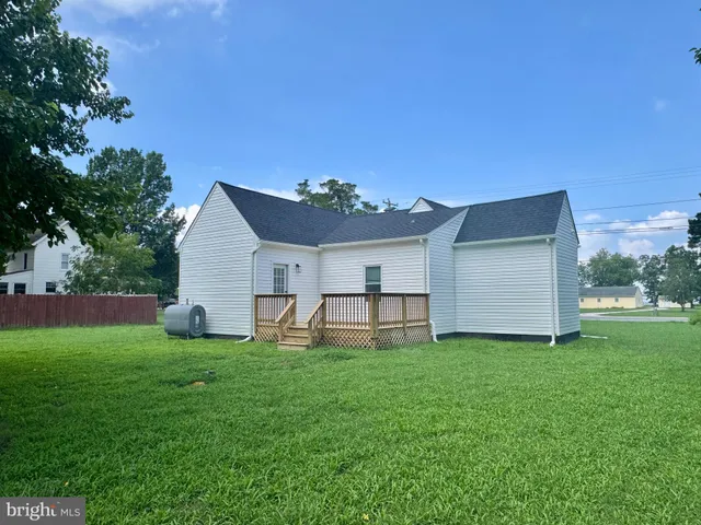 a view of a house with a yard and sitting area