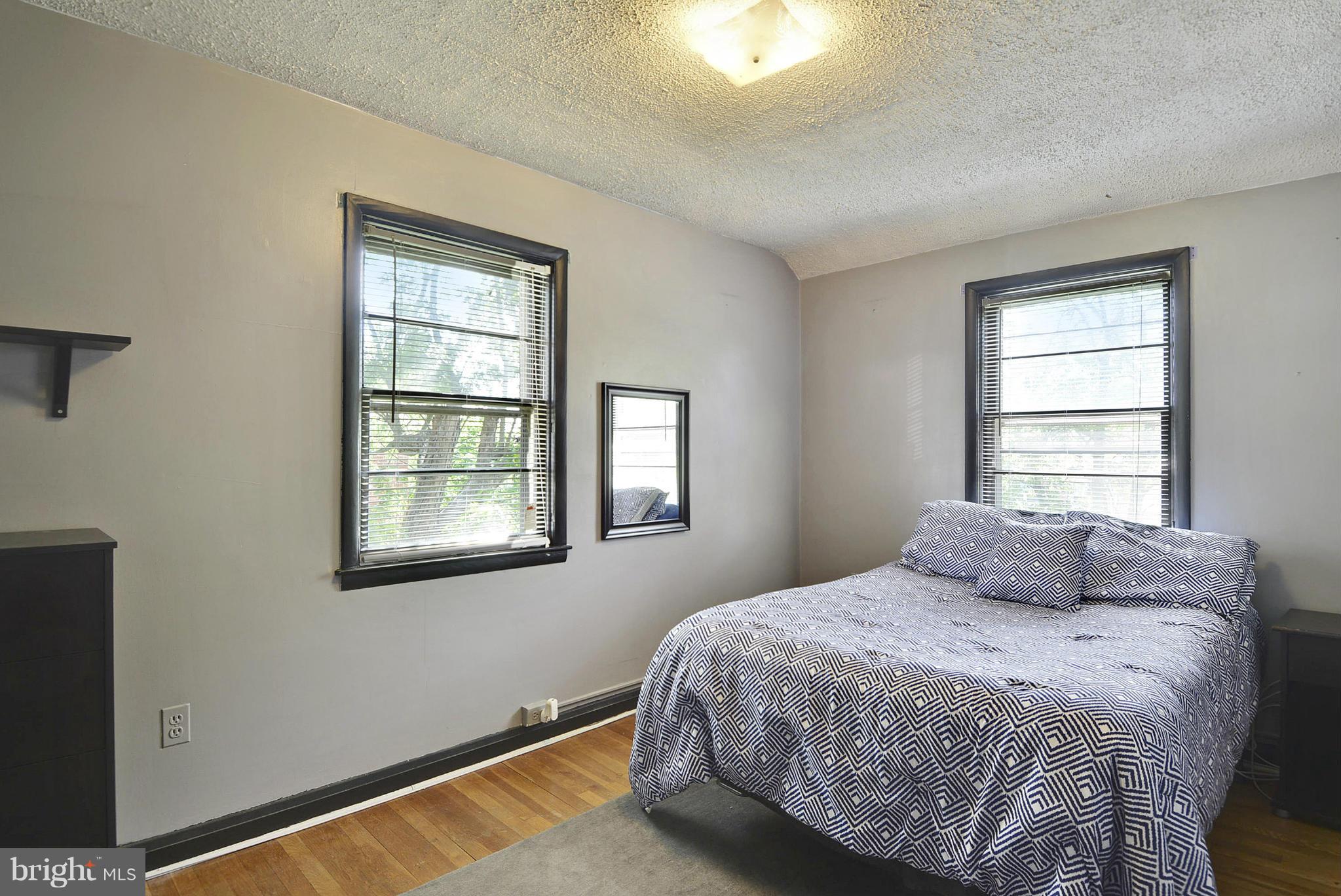 6116 Marlora Road Baltimore, MD 21239 - Photo 17 of 20 a bedroom with a bed and a window