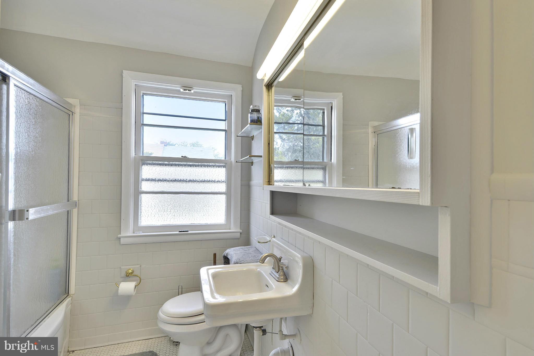 6116 Marlora Road Baltimore, MD 21239 - Photo 20 of 20 a bathroom with a sink toilet and a mirror