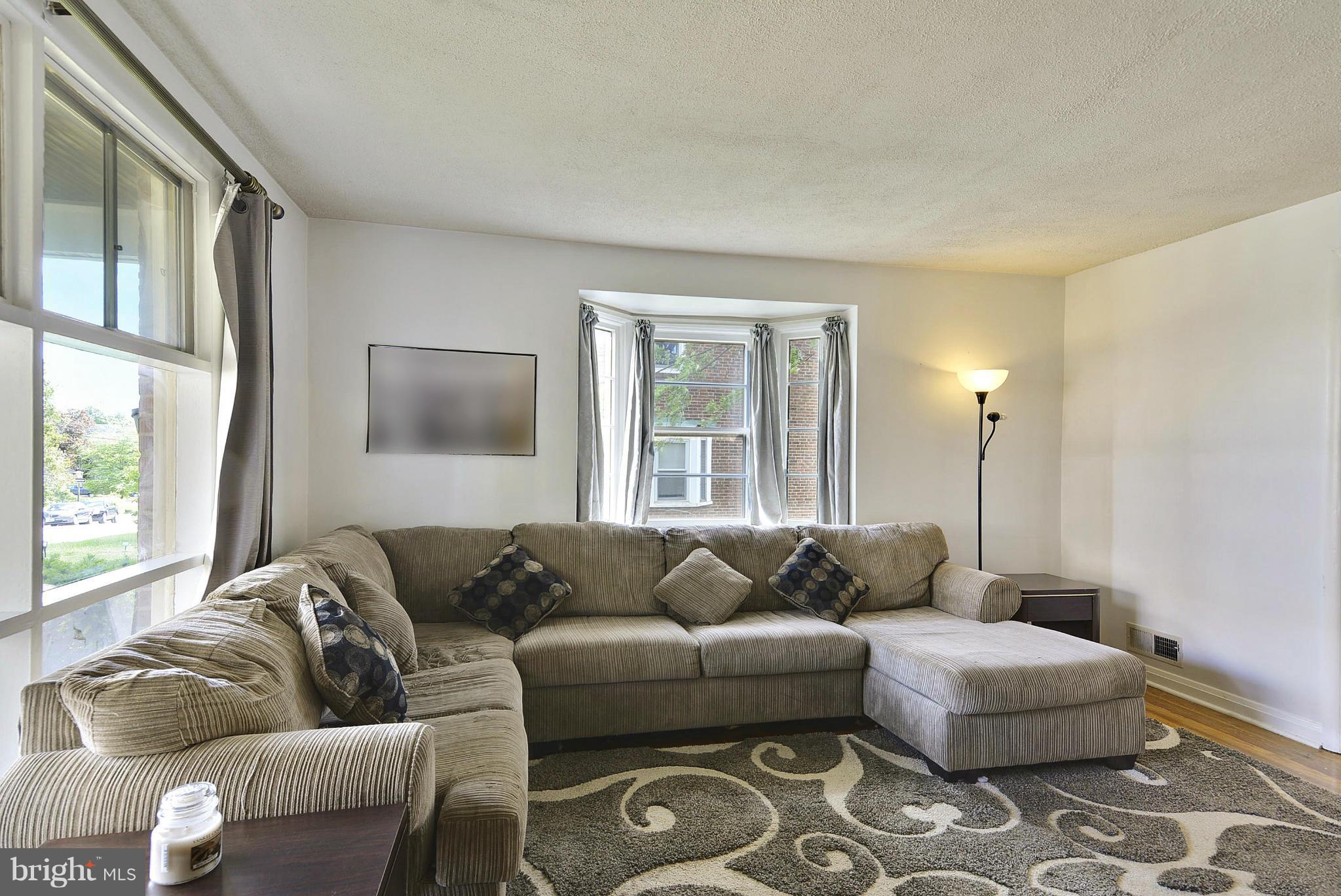 6116 Marlora Road Baltimore, MD 21239 - Photo 3 of 20 a living room with furniture and a window