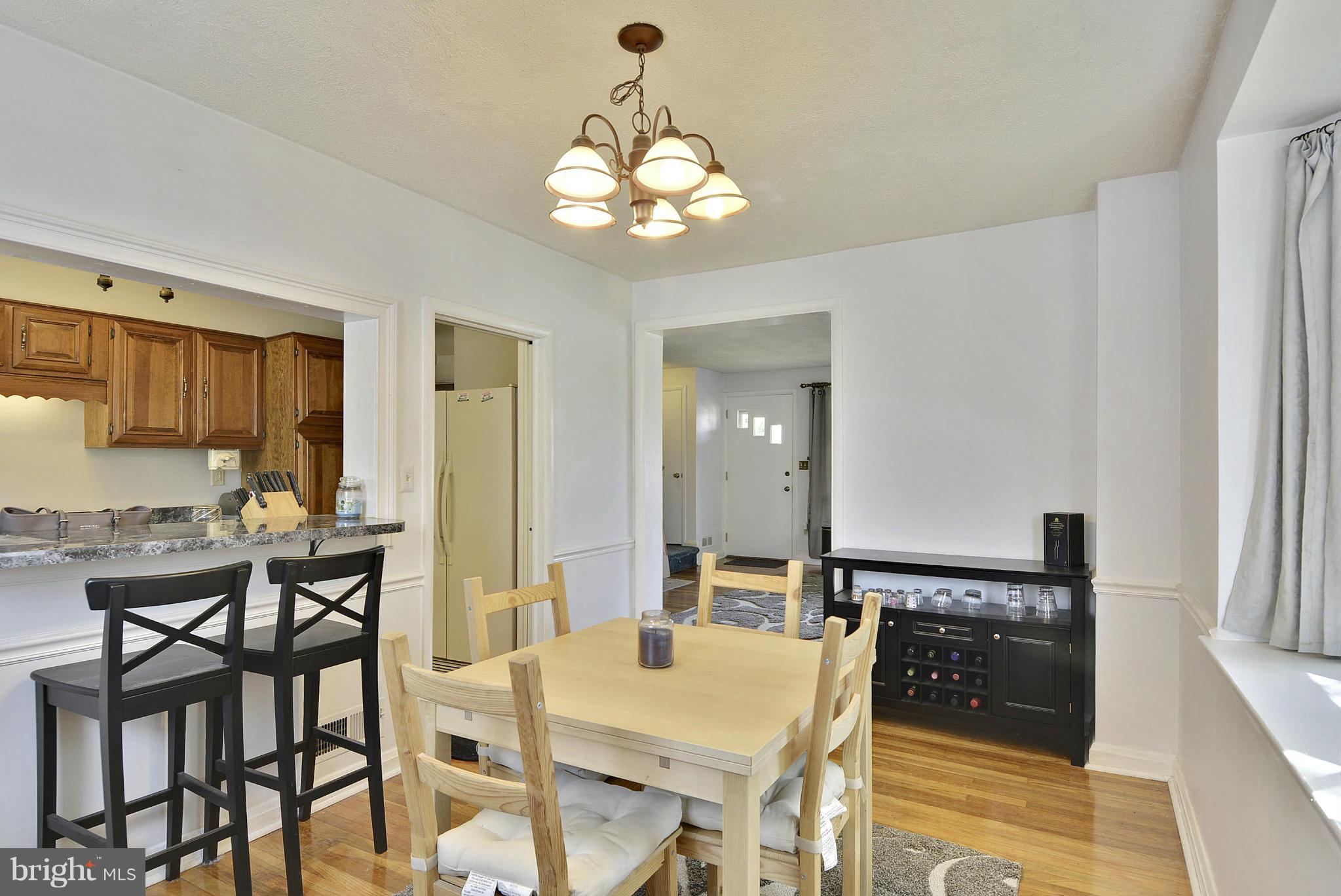 6116 Marlora Road Baltimore, MD 21239 - Photo 5 of 20 a view of a dining room with furniture and wooden floor
