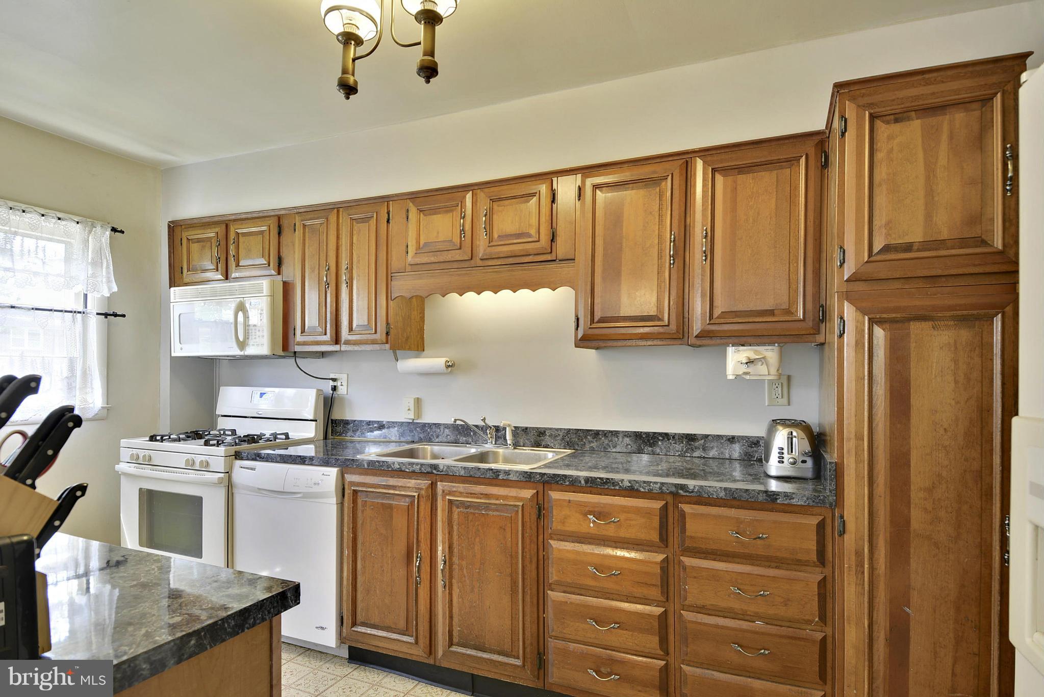 6116 Marlora Road Baltimore, MD 21239 - Photo 7 of 20 a kitchen with granite countertop a sink stainless steel appliances and cabinets