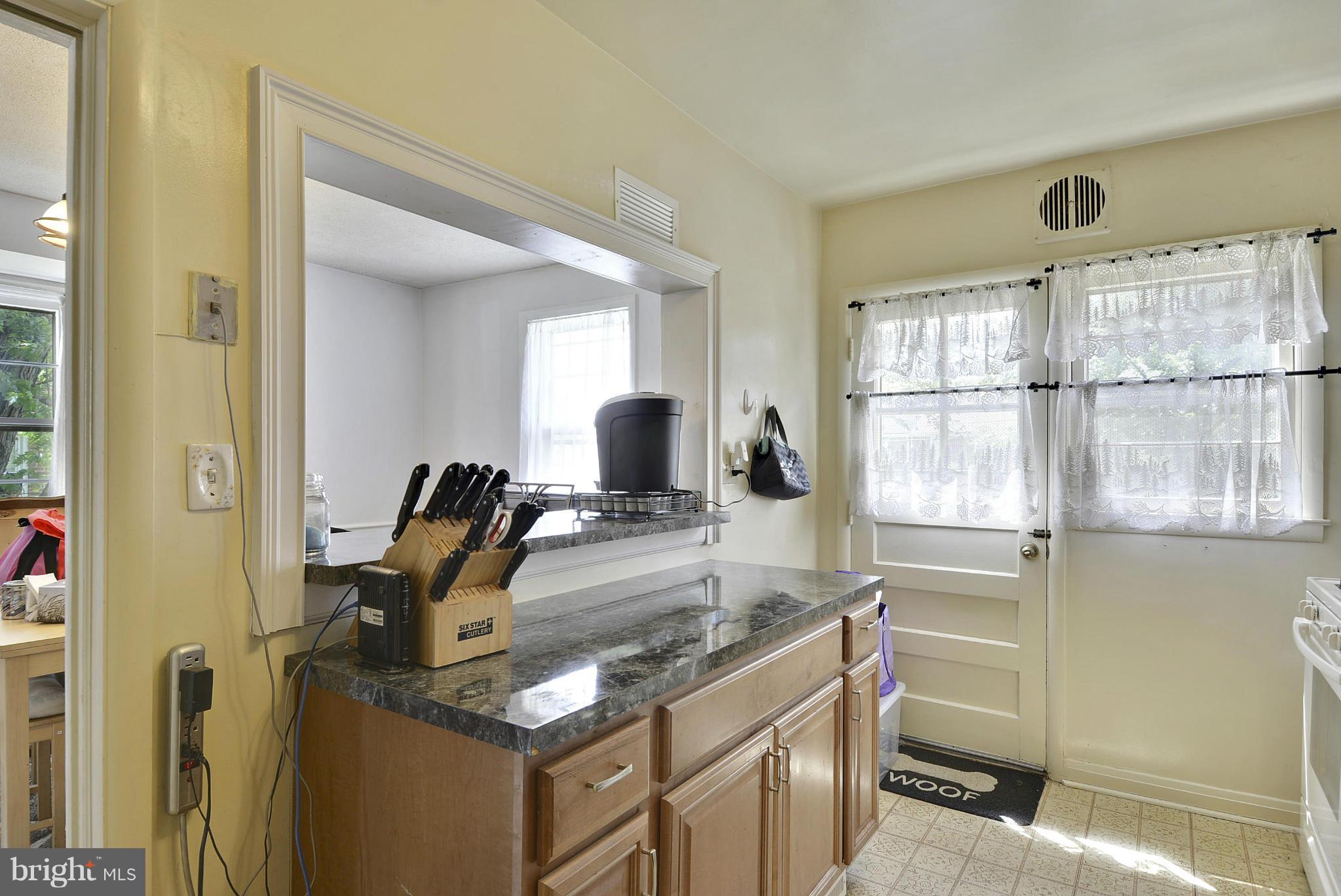 6116 Marlora Road Baltimore, MD 21239 - Photo 8 of 20 a kitchen with a stove a sink and a window