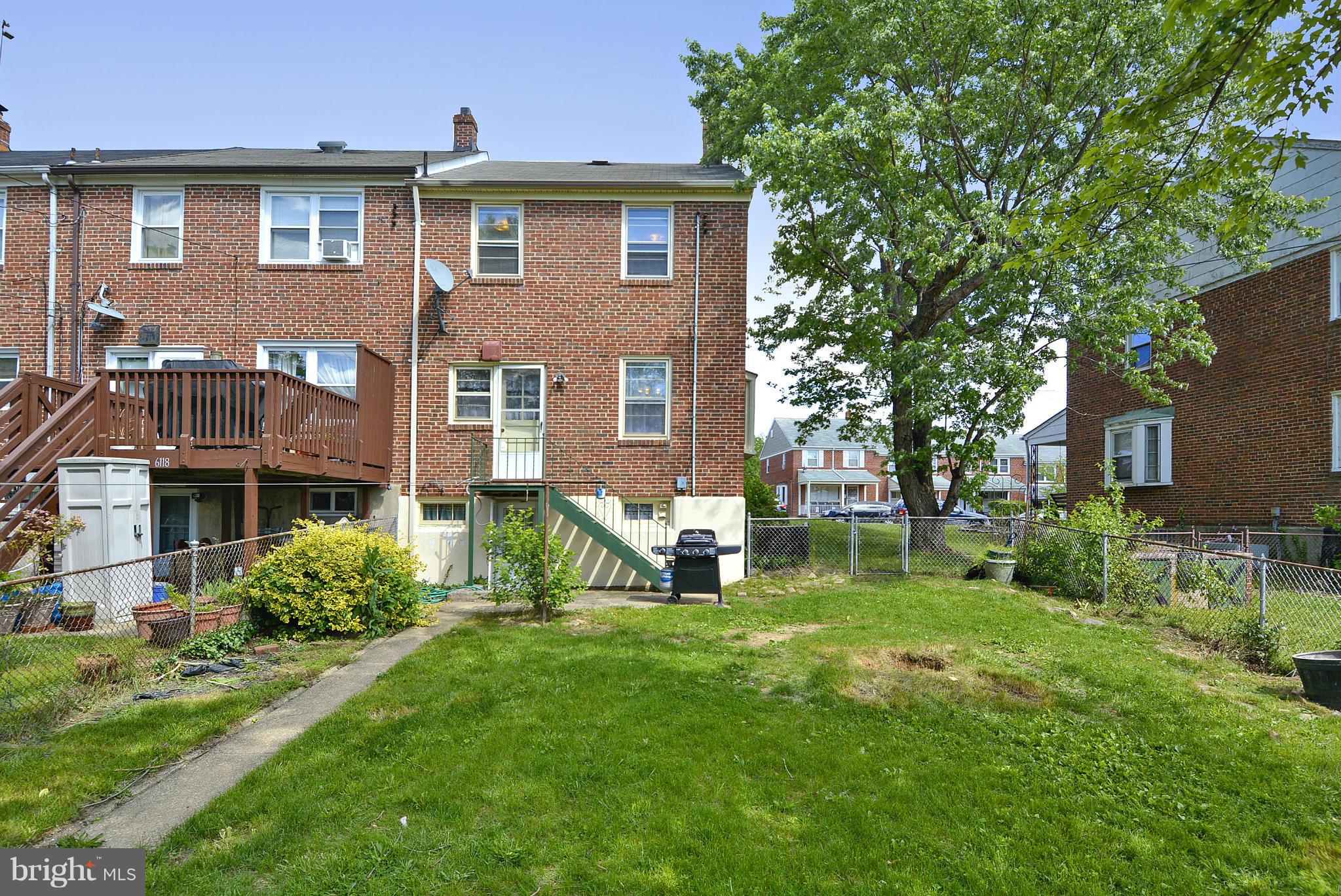 6116 Marlora Road Baltimore, MD 21239 - Photo 9 of 20 a view of a brick house with a yard and plants