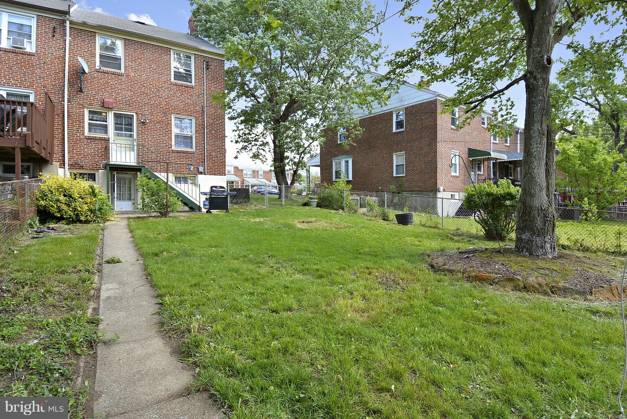 6116 Marlora Road Baltimore, MD 21239 - Photo 10 of 20 a front view of a house with a yard and green space
