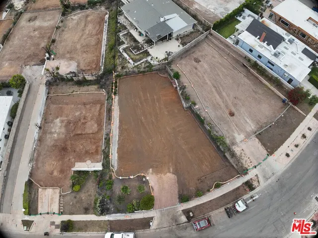 an aerial view of a residential apartment building with a yard