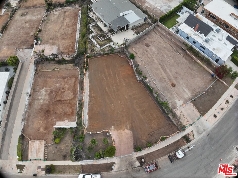 an aerial view of a residential apartment building with a yard