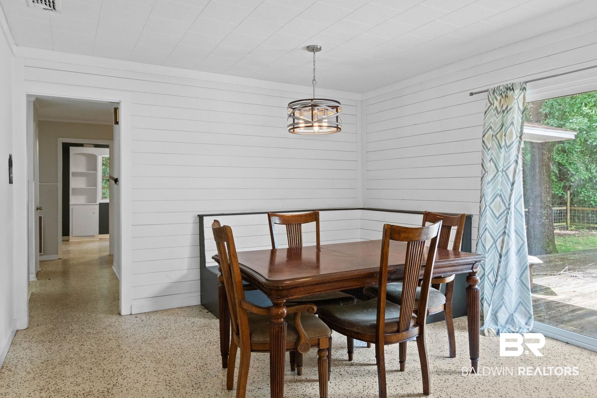 384 Old Bratt Road Atmore, AL 36502 - Photo 23 of 64 Dining area featuring shiplap walls, terrazzo-style flooring, and a contemporary drum pendant light fixture