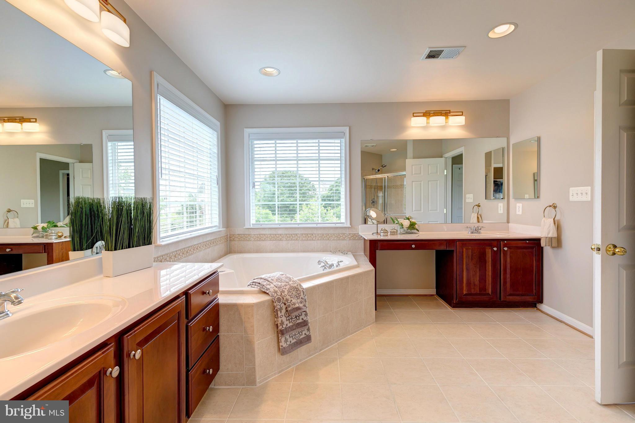 2014 Myrtlewood Road Baltimore, MD 21209 - Photo 18 of 30 a spacious bathroom with a tub sink and mirror
