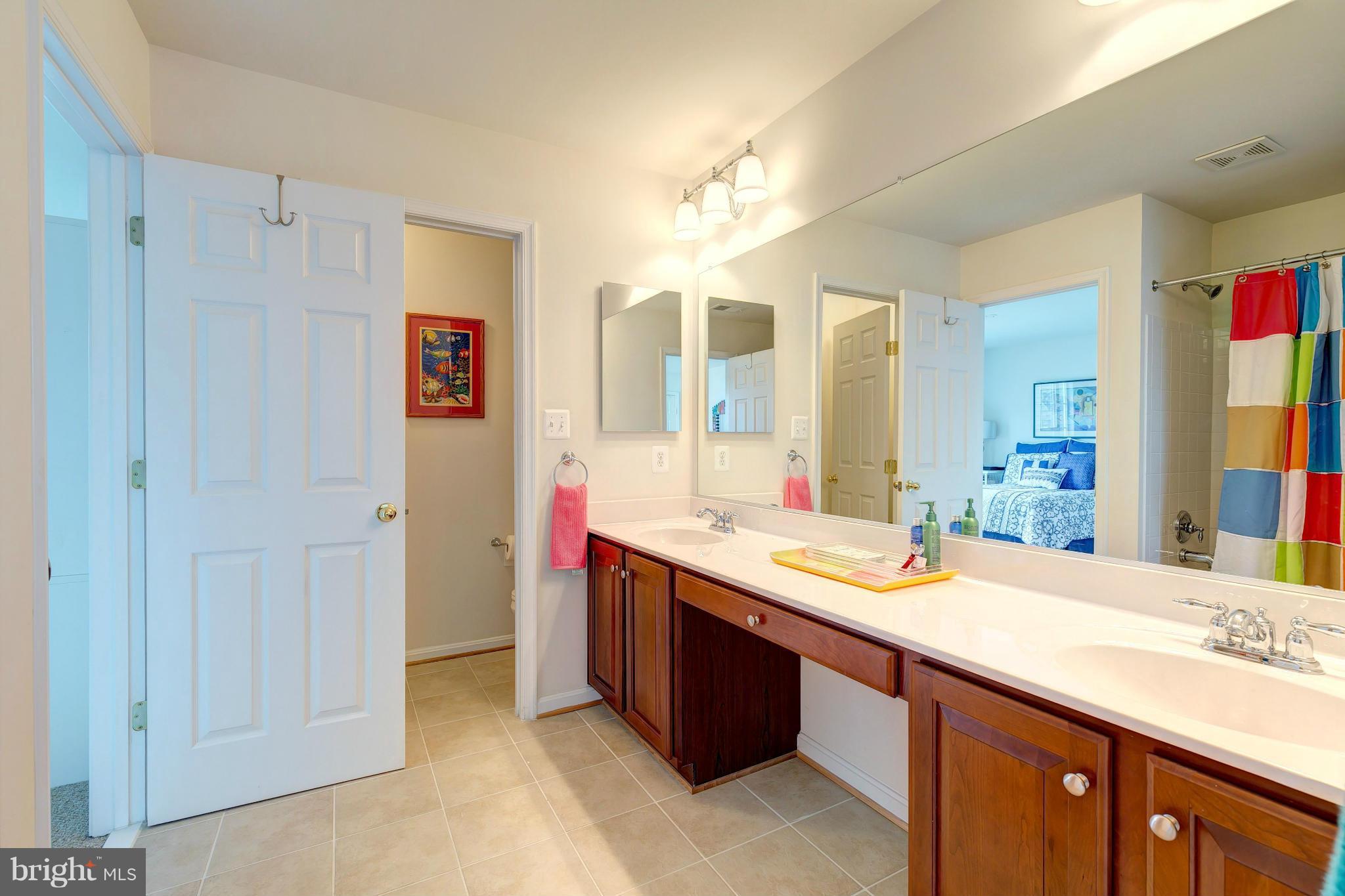 2014 Myrtlewood Road Baltimore, MD 21209 - Photo 22 of 30 a spacious bathroom with a granite countertop sink and a mirror