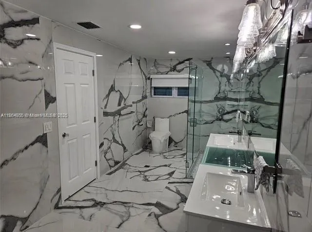 a bathroom with a sink double vanity and a mirror