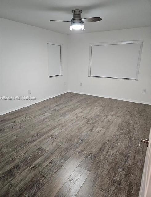 14763 Southwest 152nd Place Miami, FL 33196 - Photo 17 of 30 an empty room with wooden floor ceiling fan and windows