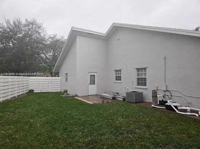 a view of a backyard with a palm tree