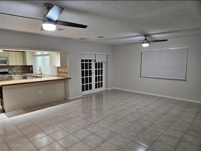 14763 Southwest 152nd Place Miami, FL 33196 - Photo 5 of 30 a view of an empty room with a window and kitchen appliances