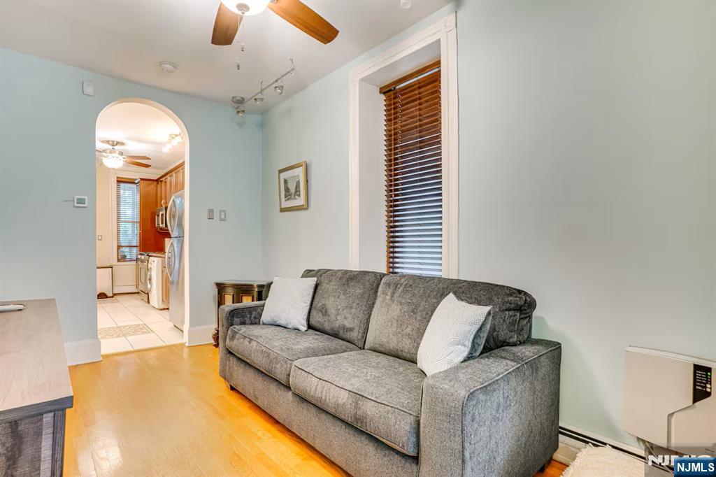 608 Madison Street, Unit 2 Hoboken, NJ 07030 - Photo 11 of 24 a living room with furniture and a chandelier